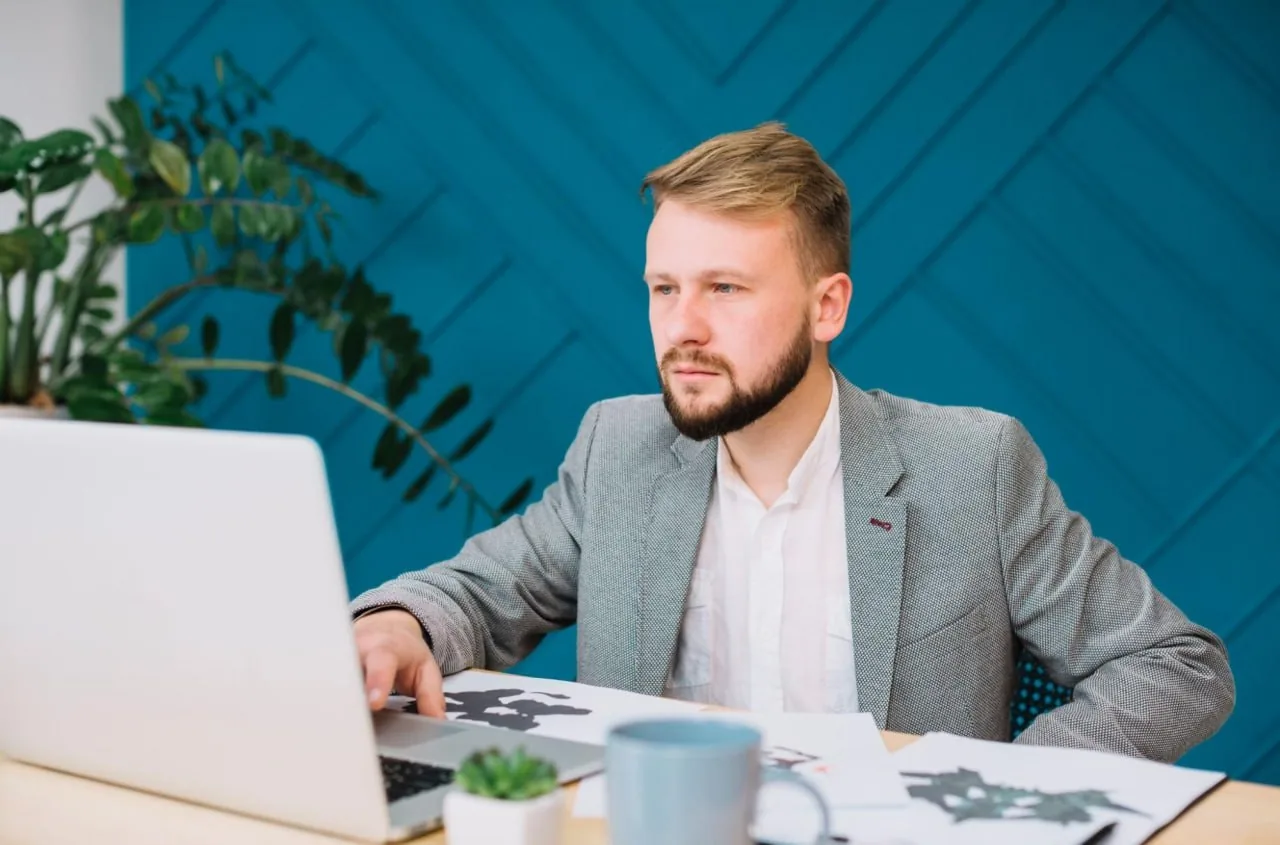 Professional man working on a laptop at an office desk