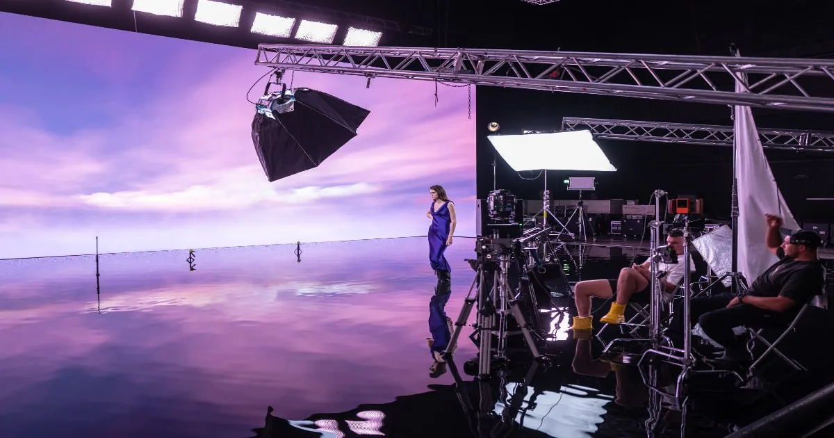 Indie creator on a studio set with crew and equipment, suggesting the production side of bringing creative projects to an audience